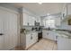 Well lit kitchen with white cabinetry, black hardware, and a window over the sink area at 538 Gertrude Ln, South Daytona, FL 32119