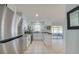 Kitchen with stainless steel appliances, light stone countertops and white cabinets with black hardware at 538 Gertrude Ln, South Daytona, FL 32119