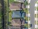 An aerial view of home showing backyard and neighborhood layout, surrounded by lush greenery at 544 Red Rose Ln, Sanford, FL 32771