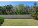 A fenced-in backyard with green grass and mature trees offering privacy and a peaceful outdoor space at 544 Red Rose Ln, Sanford, FL 32771