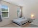 Serene bedroom with a comfortable bed, neutral decor, and bright natural light at 544 Red Rose Ln, Sanford, FL 32771