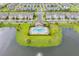 Aerial view of a luxurious neighborhood pool surrounded by lush greenery and community amenities at 544 Red Rose Ln, Sanford, FL 32771