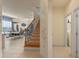 Inviting entryway with staircase, decorative wall accents, and views of the dining and living areas at 544 Red Rose Ln, Sanford, FL 32771
