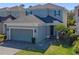 Charming two-story home with brick driveway, manicured lawn, and attached two-car garage at 544 Red Rose Ln, Sanford, FL 32771