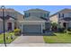 Charming two-story home with brick driveway, manicured lawn, and attached two-car garage at 544 Red Rose Ln, Sanford, FL 32771