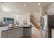 Open kitchen overlooking the living area featuring stainless steel appliances and granite countertops at 544 Red Rose Ln, Sanford, FL 32771