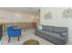 Comfortable upstairs living area with a sofa, chair, and view overlooking the railing at 544 Red Rose Ln, Sanford, FL 32771
