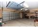 Spacious garage with overhead storage rack for organization at 553 Quail Lake Dr, Debary, FL 32713