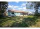 Home exterior showing a covered patio and generous backyard space at 597 Gainsboro St, Deltona, FL 32725
