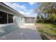 Back of home showcasing a covered patio and well-maintained lawn at 597 Gainsboro St, Deltona, FL 32725