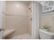 Neutral tiled bathroom featuring a shower with built-in seat and modern fixtures at 597 Gainsboro St, Deltona, FL 32725