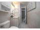 A full bathroom with white cabinets, granite countertops, and updated fixtures at 597 Gainsboro St, Deltona, FL 32725