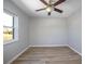 An empty bedroom showcasing natural light from the window and light wood floors at 597 Gainsboro St, Deltona, FL 32725