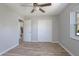Bedroom with a ceiling fan, light floors, walk-in closet, and an open doorway to the rest of the house at 597 Gainsboro St, Deltona, FL 32725