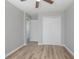 Bedroom with wood floors, a ceiling fan, open door to another room and a closet at 597 Gainsboro St, Deltona, FL 32725