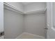 An empty walk-in closet featuring neutral paint and shelving at 597 Gainsboro St, Deltona, FL 32725