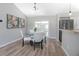 Dining area with a modern table and chairs adjacent to sliding glass doors to the exterior at 597 Gainsboro St, Deltona, FL 32725
