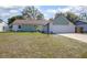 Charming single-story home featuring a well-manicured lawn and a two-car garage at 597 Gainsboro St, Deltona, FL 32725