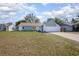 Charming home featuring well-manicured lawn, attached garage, and inviting curb appeal at 597 Gainsboro St, Deltona, FL 32725