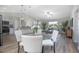 Bright open-concept living space with modern decor, wood floors, dining area, and lots of natural light at 597 Gainsboro St, Deltona, FL 32725