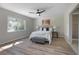 Spacious main bedroom with wood floors, a modern ceiling fan, and natural light at 597 Gainsboro St, Deltona, FL 32725