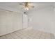 Bright bedroom featuring tile floors, ceiling fan, and a closet for ample storage space at 678 Wellington Station Blvd # 54, Ormond Beach, FL 32174