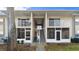 Two-story building with exterior stairways, balconies, and neutral color palette at 678 Wellington Station Blvd # 54, Ormond Beach, FL 32174