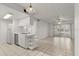 Bright kitchen and living room area features sleek white cabinets and tile flooring at 678 Wellington Station Blvd # 54, Ormond Beach, FL 32174