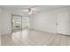 Bright living room area features tile flooring, a ceiling fan, and sliding glass doors at 678 Wellington Station Blvd # 54, Ormond Beach, FL 32174