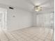 Bright living room area features tile flooring, a ceiling fan, and sliding glass doors at 678 Wellington Station Blvd # 54, Ormond Beach, FL 32174