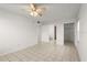 Spacious main bedroom with tile flooring, a ceiling fan, and access to the bathroom at 678 Wellington Station Blvd # 54, Ormond Beach, FL 32174