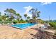 Enjoy the community pool with brick patio, palm trees, lounge chairs and table seating at 678 Wellington Station Blvd # 54, Ormond Beach, FL 32174