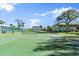 Enjoy a friendly game on the community tennis court with beautiful landscaping and clear blue skies at 678 Wellington Station Blvd # 54, Ormond Beach, FL 32174