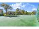 Community tennis court surrounded by lush greenery, perfect for an active lifestyle at 678 Wellington Station Blvd # 54, Ormond Beach, FL 32174