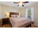 Bedroom featuring wood flooring, ceiling fan, natural light, and neutral-toned walls at 723 Pelican Ct, Kissimmee, FL 34759