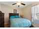 Bedroom with wood flooring, a ceiling fan, natural lighting, and a closet to the left at 723 Pelican Ct, Kissimmee, FL 34759