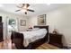 Bedroom with a ceiling fan, wood flooring, and a window offering ample natural light at 723 Pelican Ct, Kissimmee, FL 34759