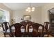 Elegant dining room featuring a large table with seating and decorative lighting at 723 Pelican Ct, Kissimmee, FL 34759