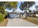 Charming single-story home featuring a well-manicured lawn, and a spacious two-car garage at 723 Pelican Ct, Kissimmee, FL 34759