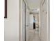 Hallway view with tiled floors leading to the bathroom and multiple closets at 723 Pelican Ct, Kissimmee, FL 34759