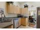 Kitchen area with stainless appliances, light wood cabinets, and an eat-in dining area at 723 Pelican Ct, Kissimmee, FL 34759