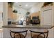Eat-in kitchen area boasts stainless appliances, counter seating and light wood cabinets at 723 Pelican Ct, Kissimmee, FL 34759