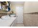 Functional laundry room with washer, dryer, tile flooring and extra storage on wire shelving at 723 Pelican Ct, Kissimmee, FL 34759