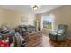 Cozy living room with beautiful hardwood floors, comfortable seating, and natural light at 723 Pelican Ct, Kissimmee, FL 34759