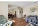 Spacious living room with hardwood floors, a dining room view, and comfortable seating at 723 Pelican Ct, Kissimmee, FL 34759