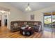 Spacious living room featuring a large sectional sofa and wood-look laminate flooring at 723 Pelican Ct, Kissimmee, FL 34759