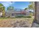 The large backyard features a screened-in pool and is surrounded by mature trees and foliage at 725 Briarcrest Dr, Orange City, FL 32763