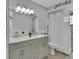 Bathroom features a double sink vanity and a tiled shower with glass door at 725 Briarcrest Dr, Orange City, FL 32763