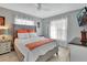Bedroom featuring a tufted headboard, light-colored wood floors, and natural light at 725 Briarcrest Dr, Orange City, FL 32763