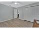 Neutral bedroom features light hardwood floors, a ceiling fan, and closet at 725 Briarcrest Dr, Orange City, FL 32763